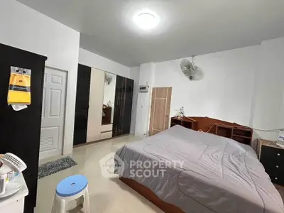 Spacious bedroom with modern furnishings and ample storage space