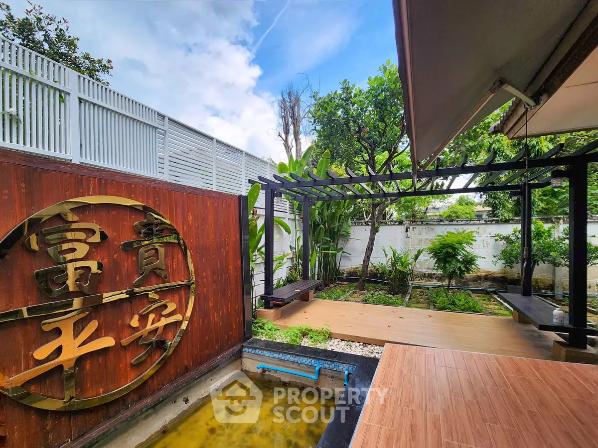 Stunning garden with wooden deck and lush greenery, perfect for relaxation and outdoor gatherings.
