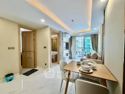 Modern open-plan living room with dining area and balcony view in a stylish apartment.