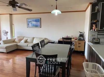 Spacious living room with dining area and modern decor in a cozy apartment.