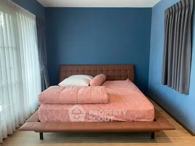 Spacious bedroom with modern design and large windows for natural light