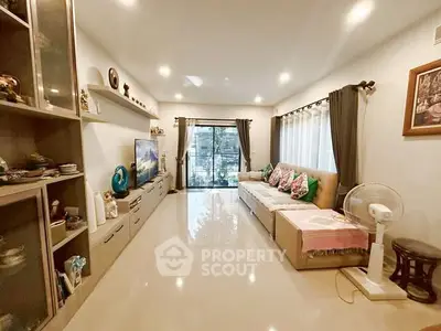 Spacious living room with modern decor and large windows for natural light.