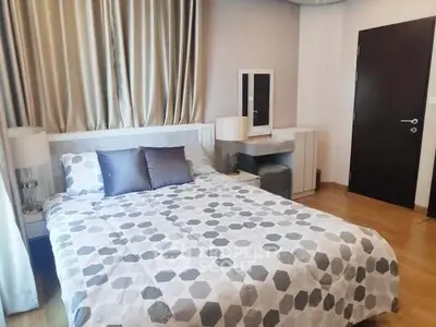 Cozy bedroom with modern decor and stylish bedding in a contemporary apartment.