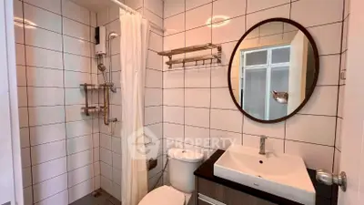 Modern bathroom with sleek fixtures and stylish round mirror
