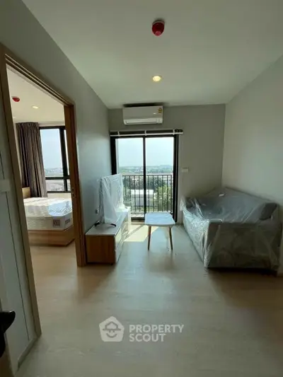 Modern living room with balcony view in a high-rise apartment