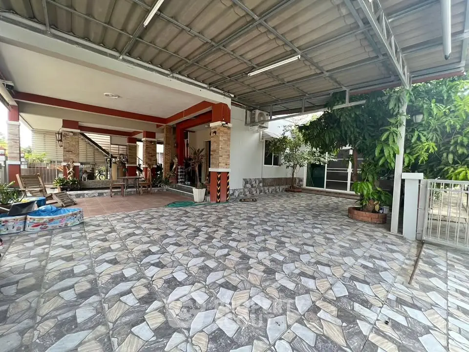 Spacious covered parking area with tiled flooring and garden view
