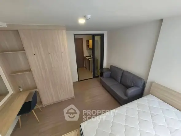Modern studio apartment with cozy living area and workspace