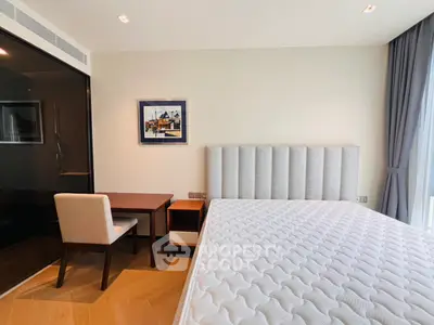 Modern bedroom with stylish decor and large window for natural light