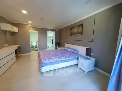 Spacious modern bedroom with ensuite bathroom and stylish decor