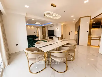 Luxurious open-plan living and dining area with modern furnishings and elegant lighting.