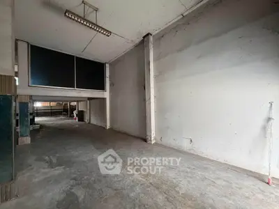 Spacious industrial warehouse with high ceilings and ample storage space.