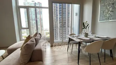 Modern living room with elegant dining area and city view from balcony.