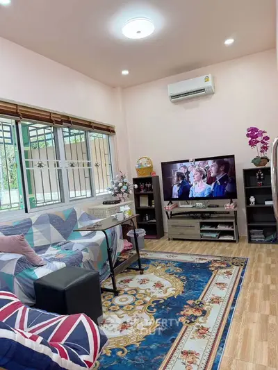 Charming living room with cozy decor and modern entertainment setup