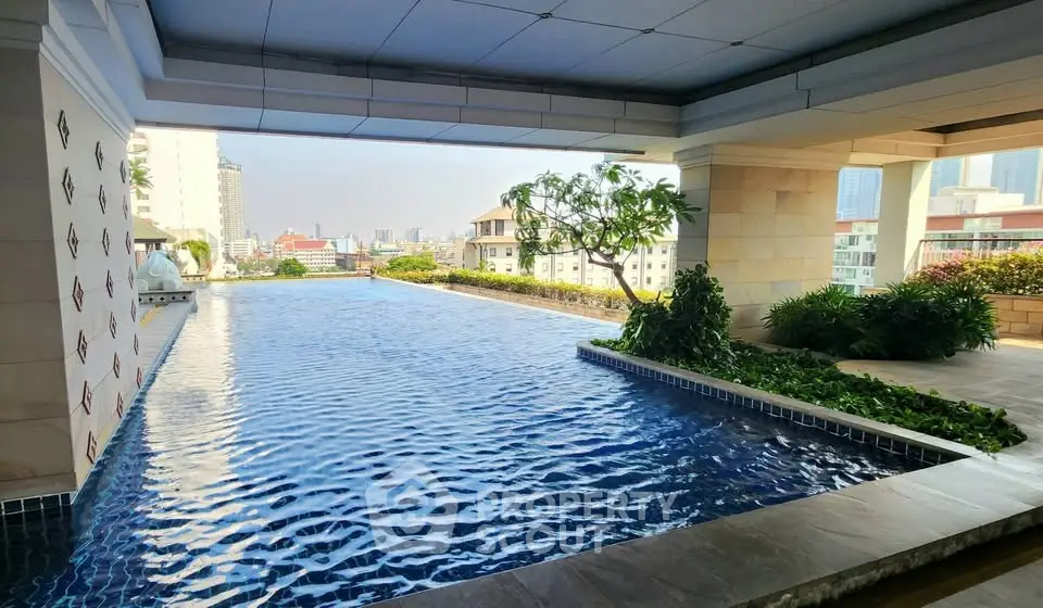 Luxurious rooftop pool with stunning city views and lush greenery, perfect for relaxation and leisure.