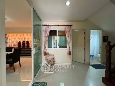 Spacious interior with sliding glass doors and elegant decor, perfect for modern living.
