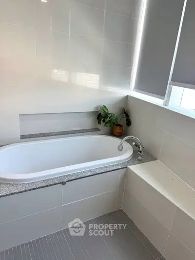 Modern bathroom with sleek bathtub and stylish tile design