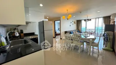 Spacious open-plan kitchen and living area with modern furnishings and balcony view.