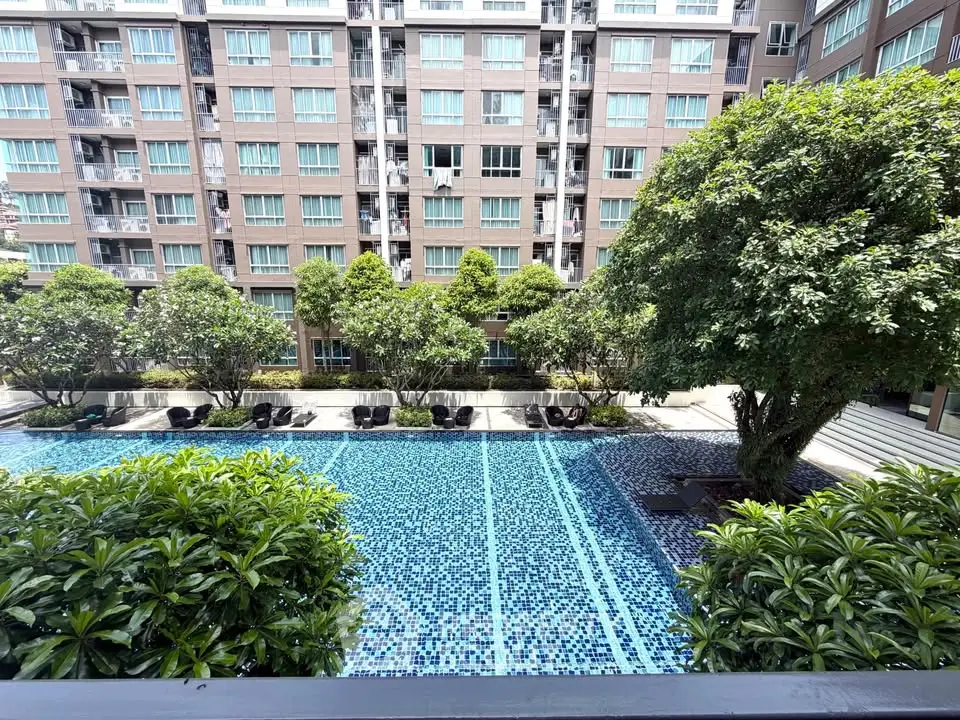 Luxurious apartment complex with stunning pool and lush greenery