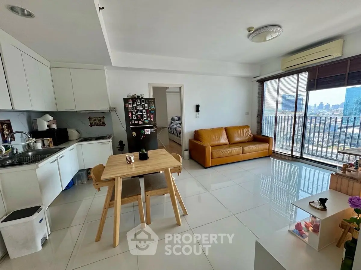 Modern open-plan living room with kitchen and city view balcony