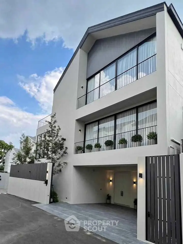 Modern three-story building with sleek design and large windows, perfect for contemporary living.