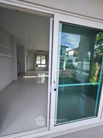Spacious modern living room with large sliding glass doors and garden view