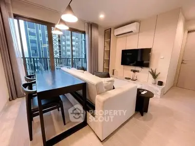 Modern living room with sleek furniture and city view balcony in luxury apartment.
