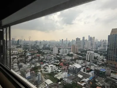 Stunning cityscape view from high-rise building window, showcasing urban skyline and architecture.