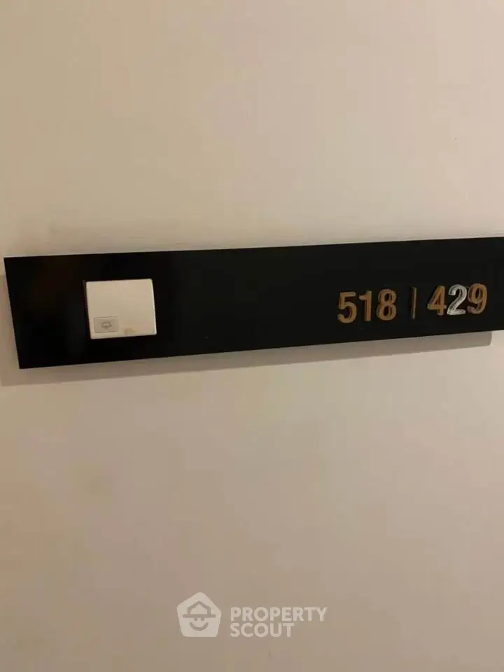 Modern apartment number plaque with sleek design and room numbers 518 and 429.