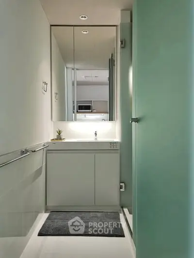 Modern minimalist bathroom with sleek design and large mirror