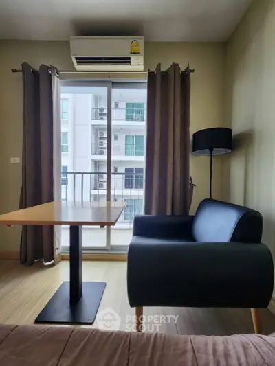 Modern apartment interior with cozy seating and balcony view