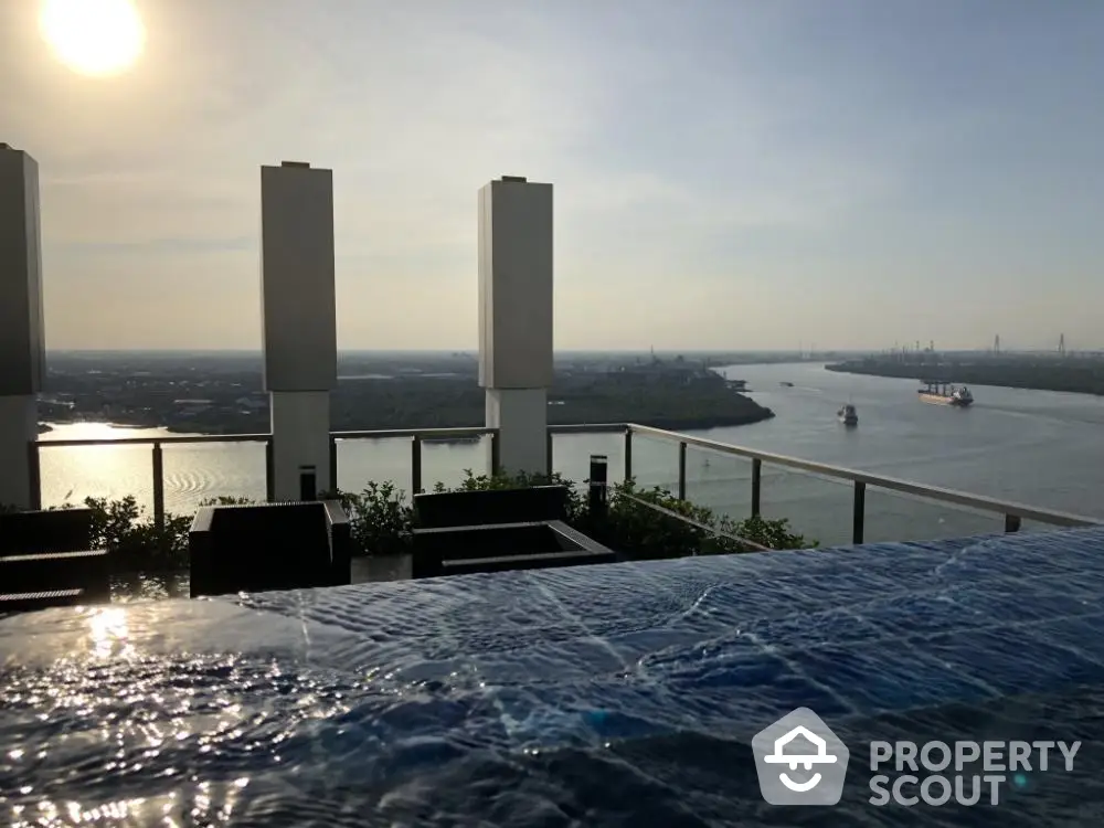 Luxurious rooftop infinity pool with panoramic river views, perfect for high-end real estate listings and upscale living.