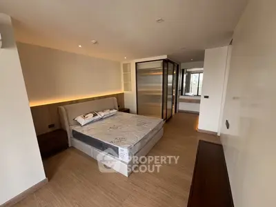 Spacious modern bedroom with elegant design and ample natural light
