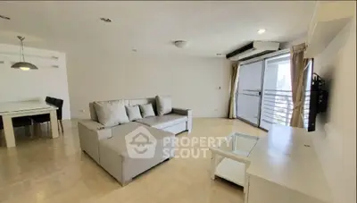 Spacious modern living room with large windows and stylish furniture.