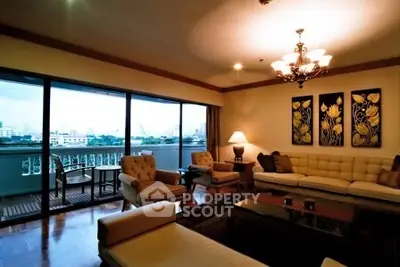 Luxurious living room with elegant decor and stunning city view from large windows.