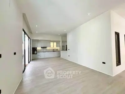 Spacious open-plan living room with modern kitchen and sleek design