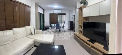 Spacious modern living room with white leather sofa and large TV unit
