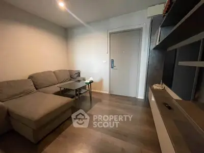 Cozy living room with modern sectional sofa and sleek entertainment unit.