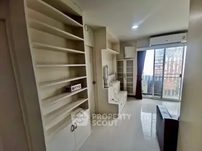 Modern living room with built-in shelves and balcony access