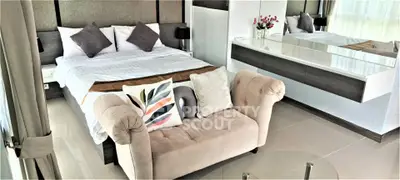 Luxurious bedroom with elegant decor and plush seating in modern apartment