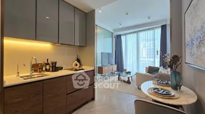 Modern open-layout kitchen and living room with stylish decor and natural light.