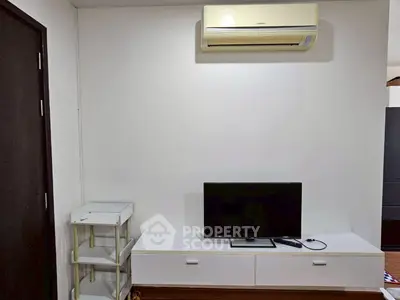 Modern living room with sleek TV unit and air conditioning, perfect for cozy entertainment.