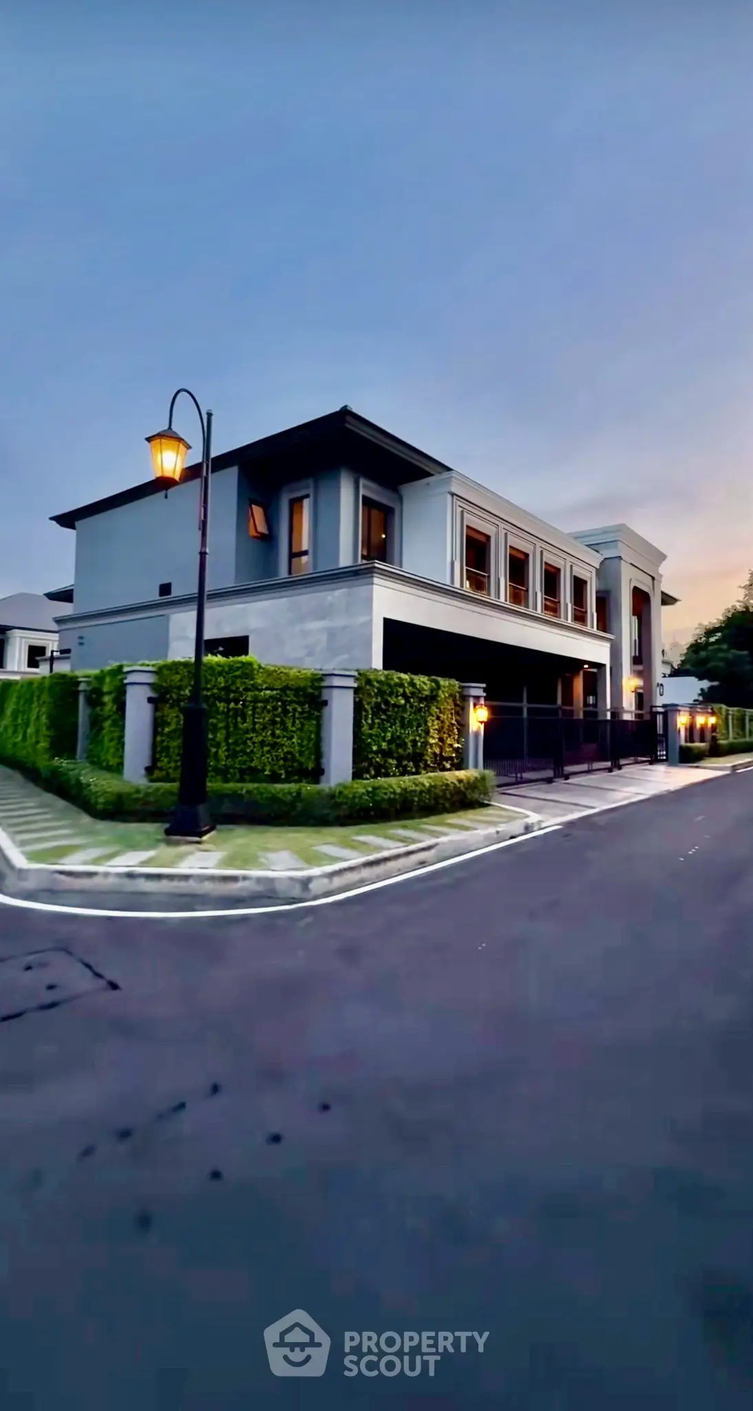 Luxurious modern corner unit house with elegant exterior design and lush greenery.