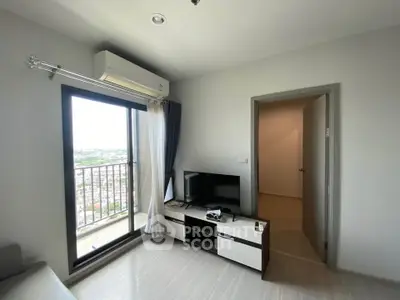 Modern living room with balcony view and sleek furniture in a high-rise apartment.