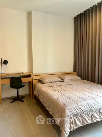 Modern bedroom with cozy bed and study desk, perfect for relaxation and productivity.