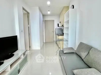 Modern living room with sleek furniture and bright lighting in a contemporary apartment.