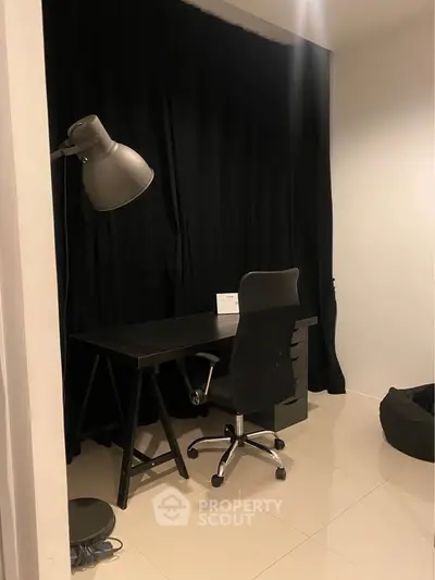 Modern study room with sleek black desk and chair, perfect for productivity and focus.