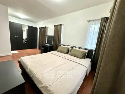 Spacious bedroom with modern furnishings and ample natural light, perfect for relaxation and comfort.