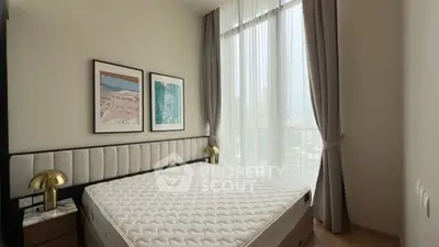 Modern bedroom with large windows and stylish decor in a high-rise apartment.