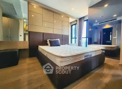 Modern bedroom with stylish design and large windows in luxury apartment.