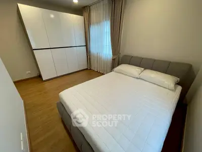 Modern bedroom with sleek wardrobe and cozy bed in a stylish apartment